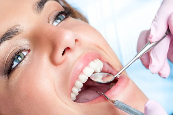 Dentist working on girls teeth