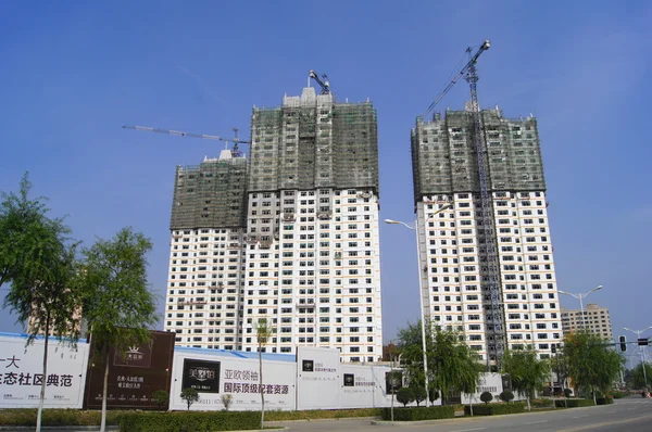 Heihe. Three white building under construction