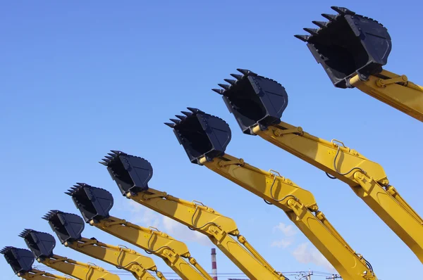 Excavator buckets against the blue sky