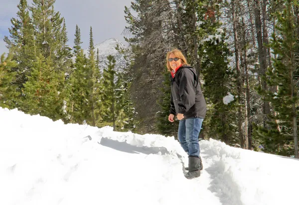 Senior female on snowy park trail
