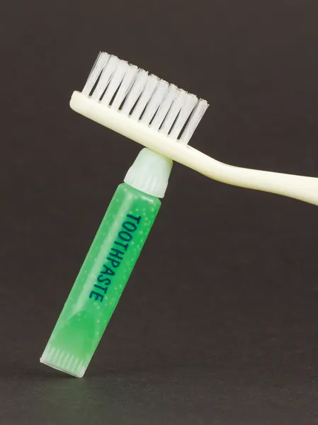 Toothbrush and green toothpaste isolated