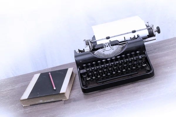 Vintage typewriter and old books