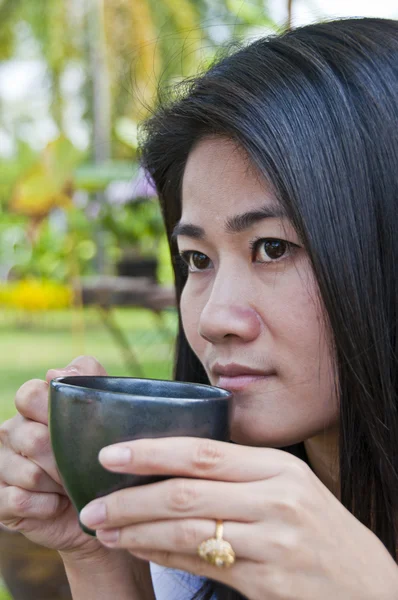 Beautiful Asian woman enjoy coffee.