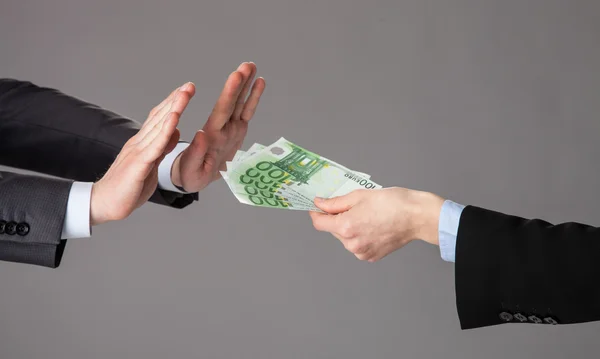 Businessman\'s hands rejecting an offer of money