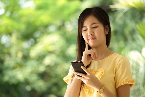 Portrait beautiful Asian Girl play smart phone