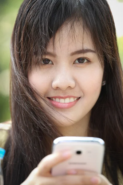 Portrait beautiful Asian Girl play smart phone