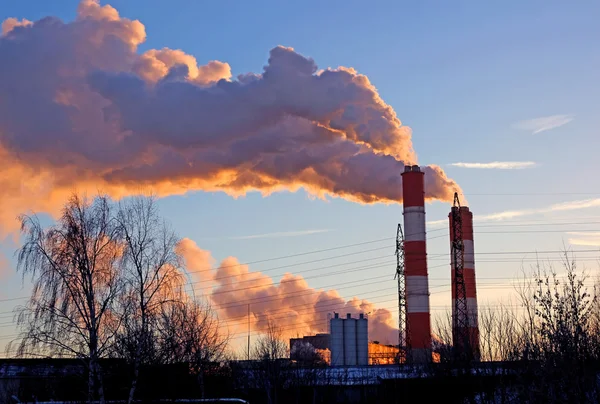 Factory chimneys smoke rising into the sky