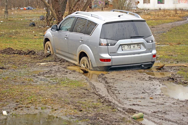Car stuck in the mud Mitsubishi Outlander