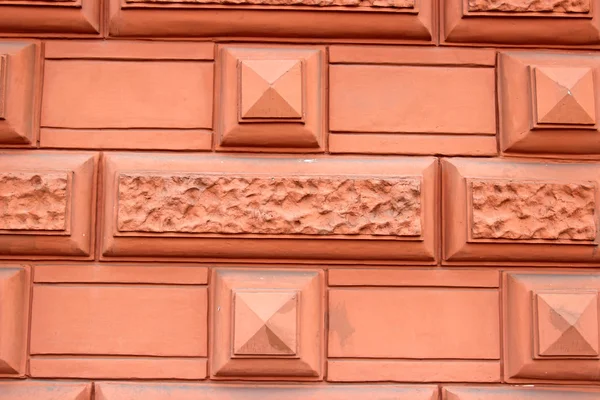 Fragment of a pink wall with an ornament