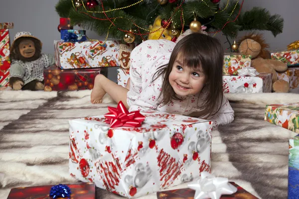 The girl with a gift under the Christmas tree