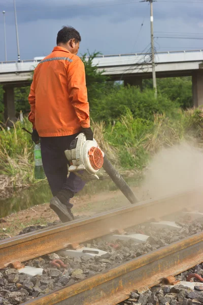 Workers clean the tracks for maintenance.