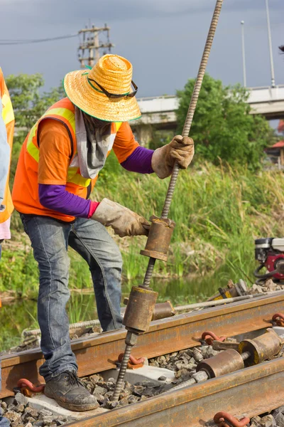 Workers preparing equipment for maintenance of the railway.