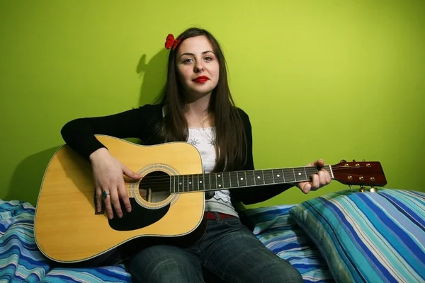 Girl enjoys playing guitar