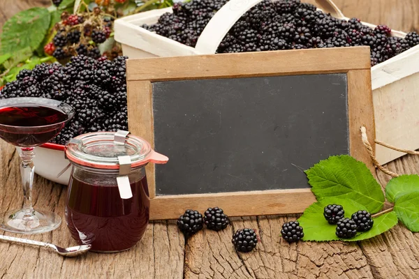 Ripe blackberries and a jar blackberry jelly