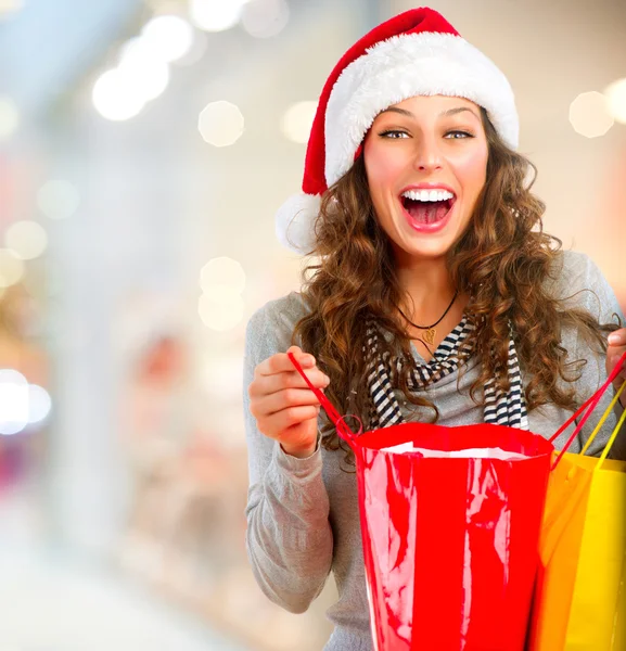 Christmas Shopping. Happy Woman with Bags in Mall. Sales