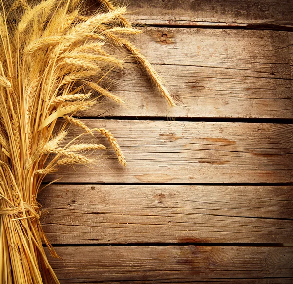 Wheat Ears on the Wooden Table. Harvest concept