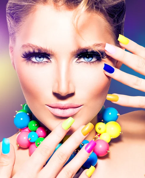 Beauty model girl with colorful nails