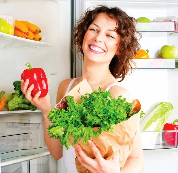 Woman near the refrigerator with  food
