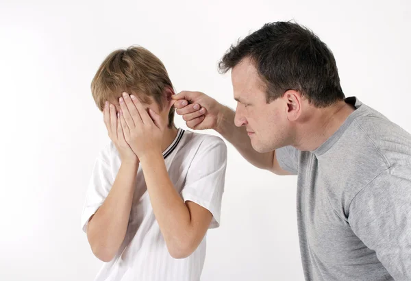 Strict father punishes his son. Isolated on white background