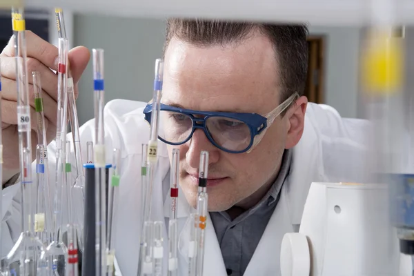 Scientist with laboratory pipettes