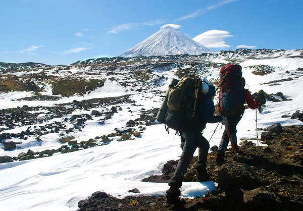 Two hikers walking in snow mountains