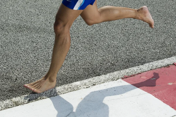 Closeup of a runners feet barefoot running