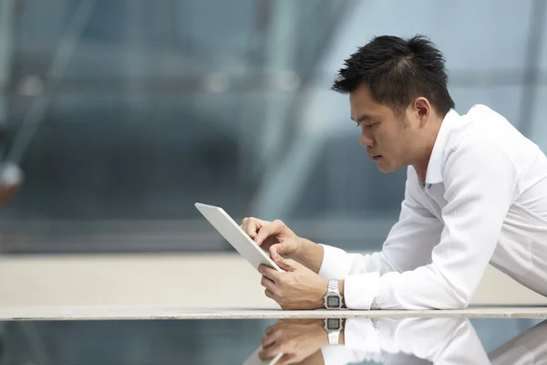 Asian Business man using a Digital Tablet