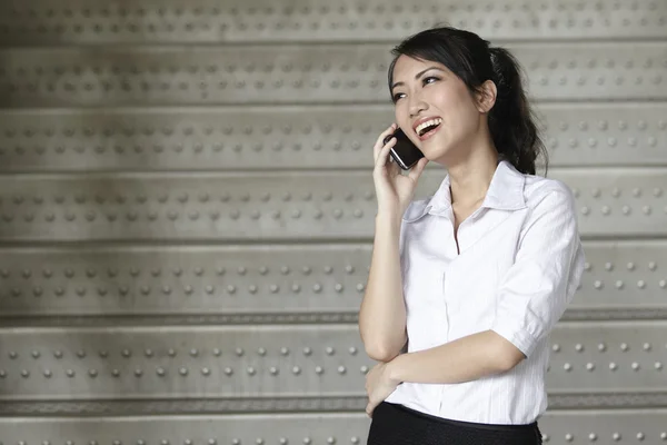 Asian Business woman using a Cell Phone