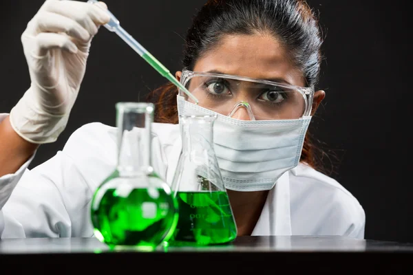 Woman scientist analyzing a solution.