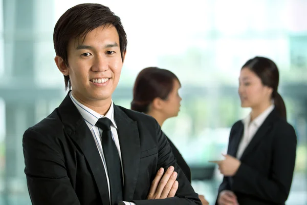 Asian Business man with colleague\'s in background
