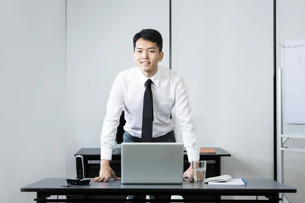 Chinese business man standing in office