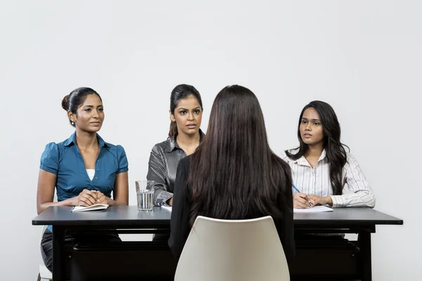 Panel of indian women interview applicant.