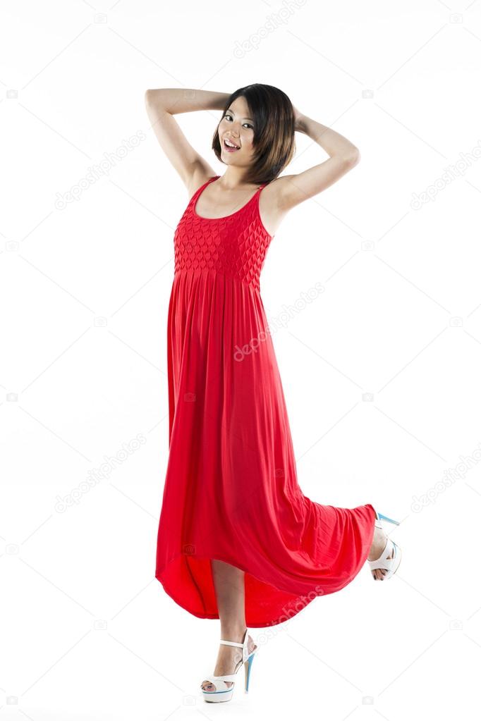 Happy Chinese woman wearing red summer dress - Stock Image