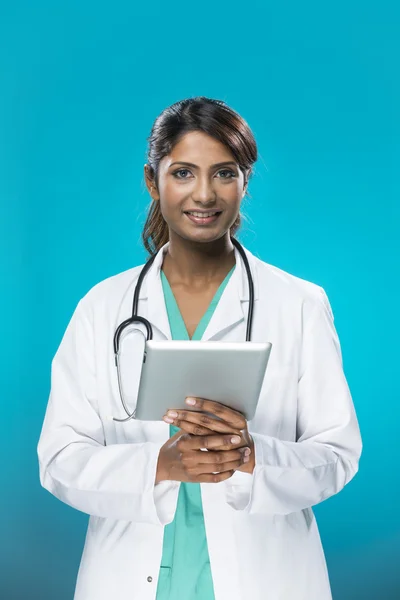Portrait of a Female indian, doctor holding a digital tablet.