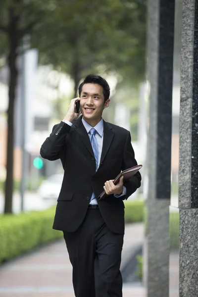 Chinese business man using a smartphone.