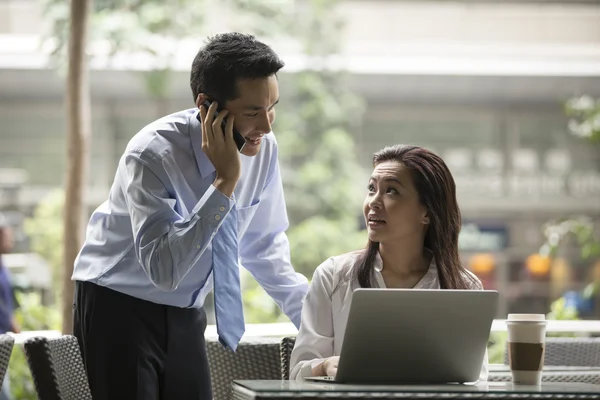 Asian business people working together on a laptop