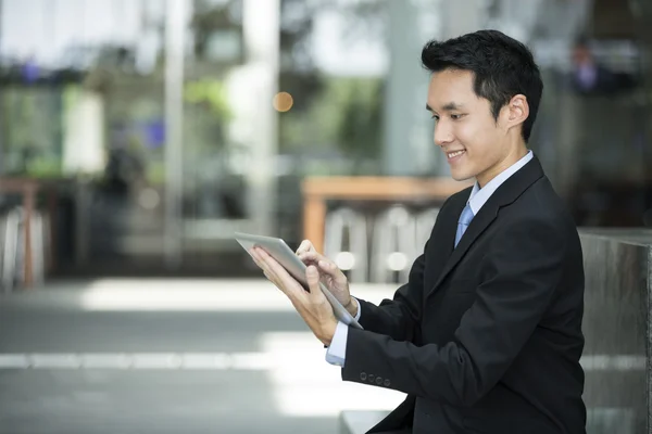 Chinese man with a tablet computer.