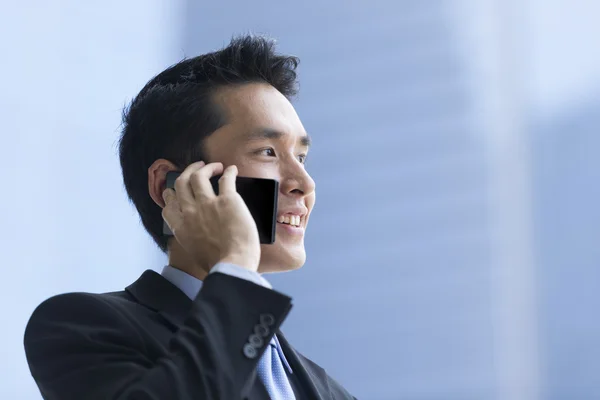 Chinese business man using a smartphone.