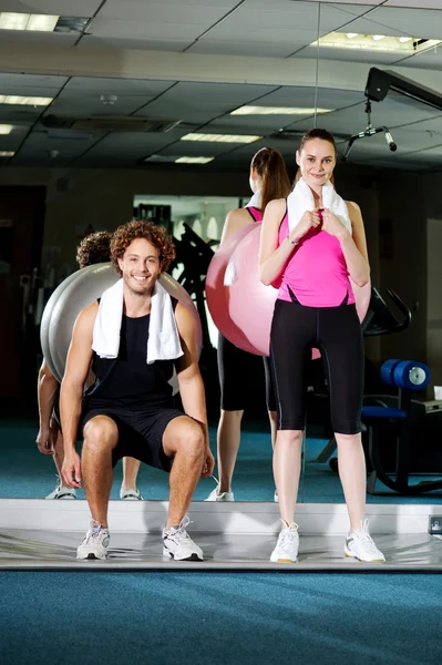 Gym friends working out with the exercise ball