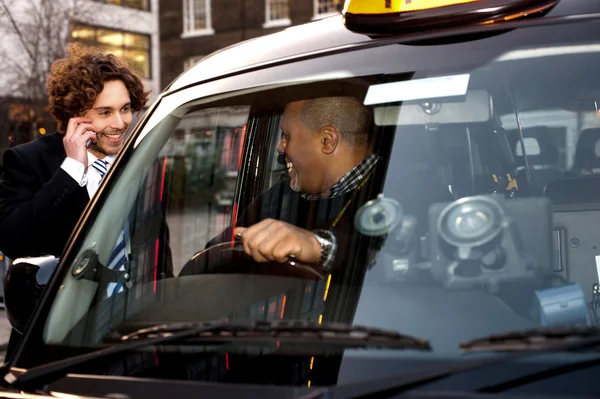 Businessman interacting with taxi driver