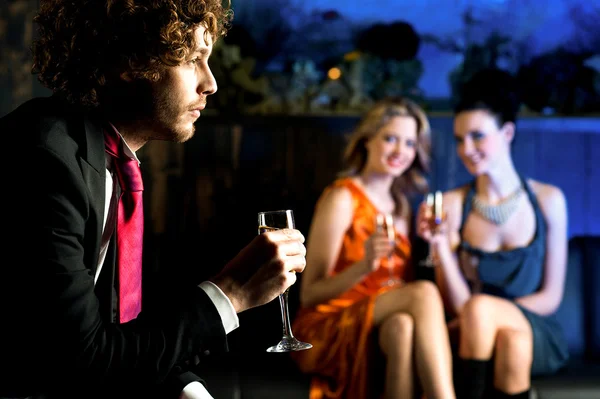 Flirtatious young girls staring at handsome guy