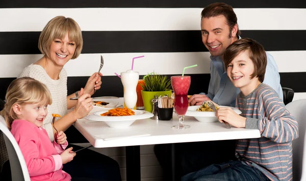 Family eating lunch together in restaurant