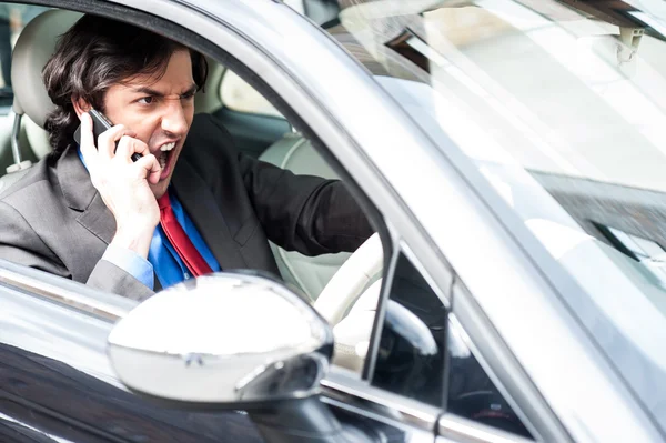 Angry businessman shouting while driving