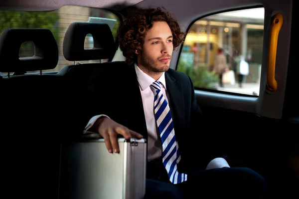 Handsome businessman inside taxi cab