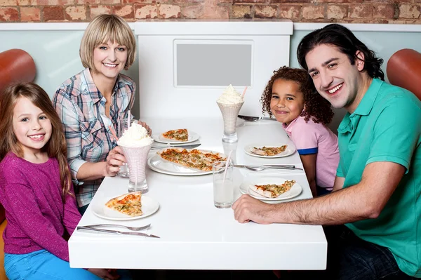 Cheerful family of four enjoying dinner