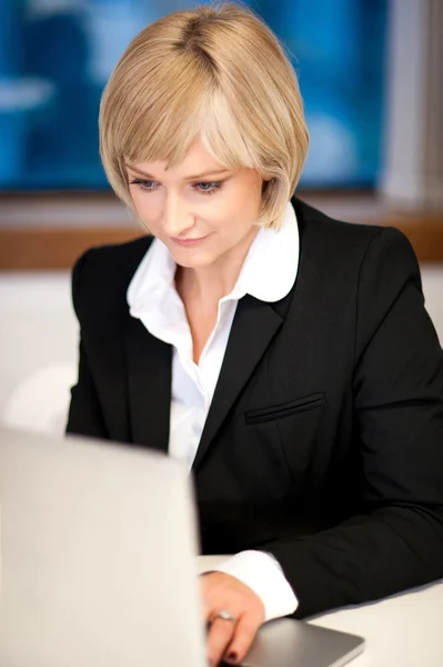 Corporate lady working on laptop
