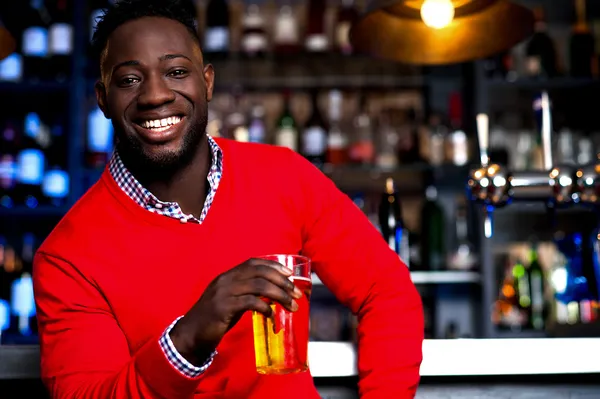 African guy posing with chilled beer