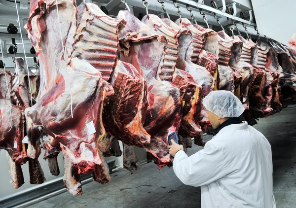 Cutting meat in a meat factory