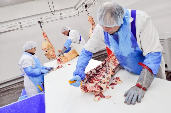 Cutting meat in a meat factory