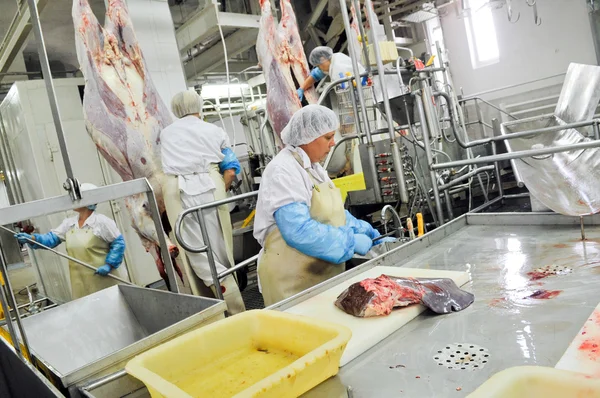 Cutting meat in a meat factory